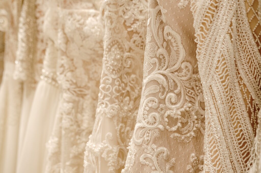Cream wedding dresses hanging on the hanger. Bridal fashion concept